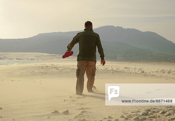 Man Walking On Sand