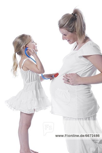 Daughter Listening To Mother's Pregnant Belly