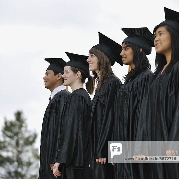 Diverse University Graduates Outside Together