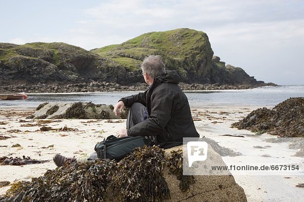 Man Sitting At The Beach  Island Of Iona  Scotland
