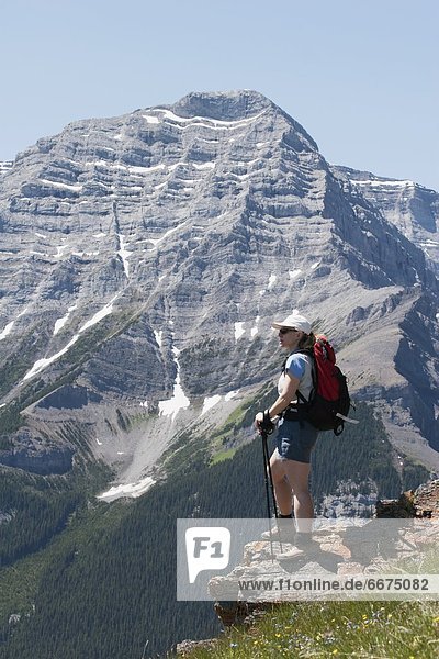 Woman Standing On The Top Of A Mountain