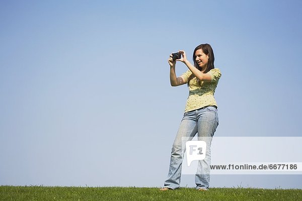 A Girl Taking A Picture With Her Camera