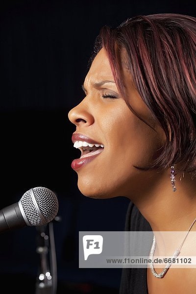 Woman Singing Into Microphone