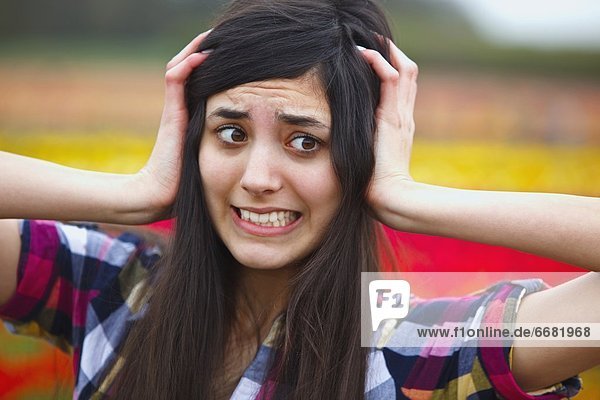A Girl Holding Her Head With A Crazy Face
