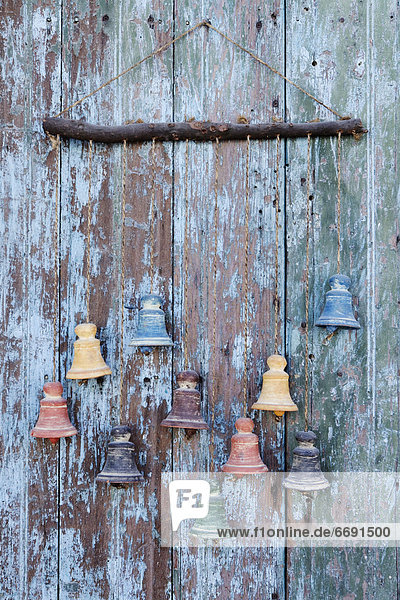 Clay Bells on a Weathered Door