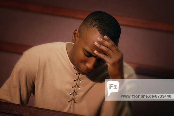 Man Sitting In Church Pew