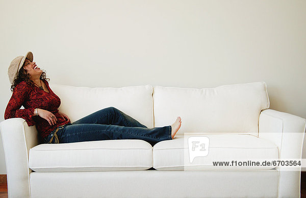Woman Relaxes On Sofa
