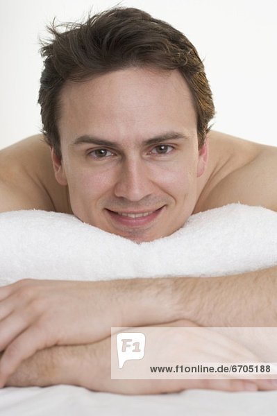 Headshot of smiling man with towel