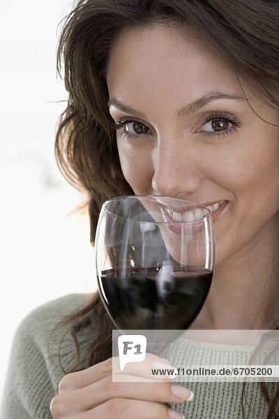 Smiling woman drinking red wine