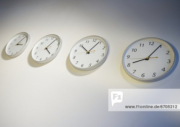 Row of clocks indicating different times
