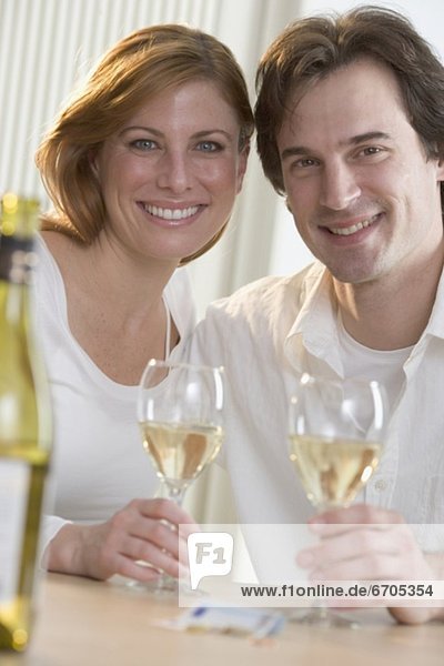 Smiling couple with white wine