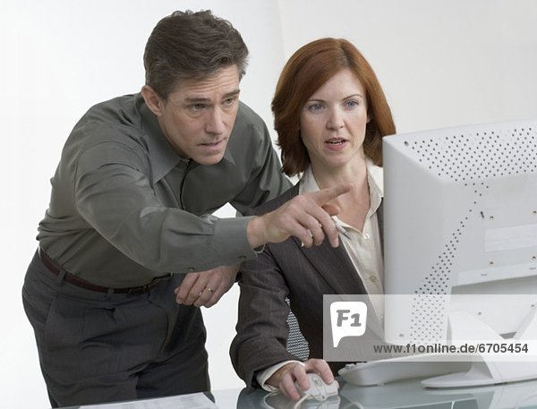 Business people looking at computer screen