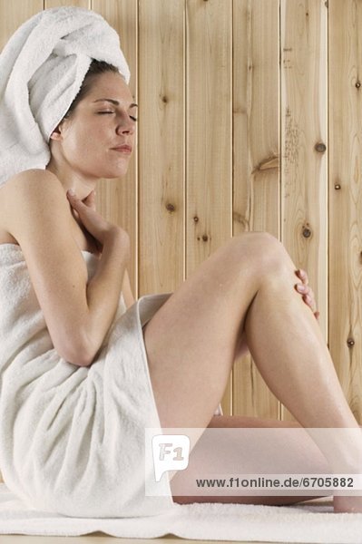 Woman relaxing in sauna