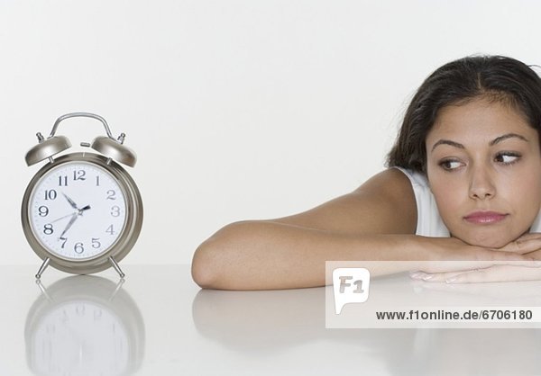 Woman looking at alarm clock
