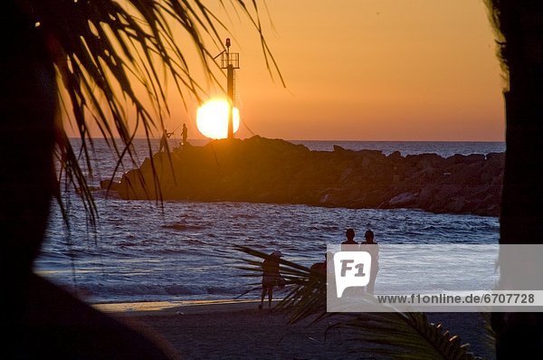 People On Beach At Sunset