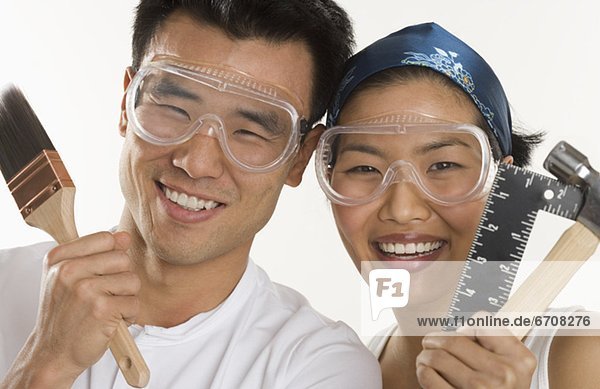 Portrait of couple doing home repairs