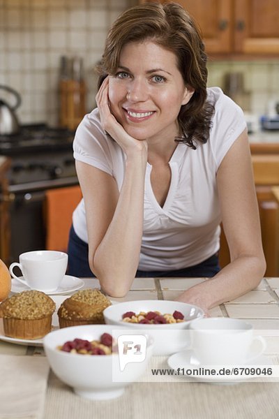 Woman in kitchen with breakfast food
