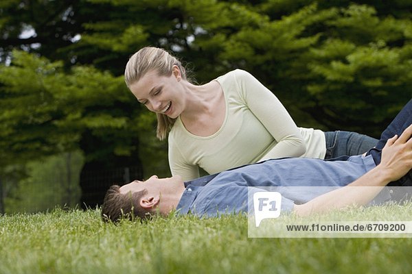 Affectionate couple on grass in park
