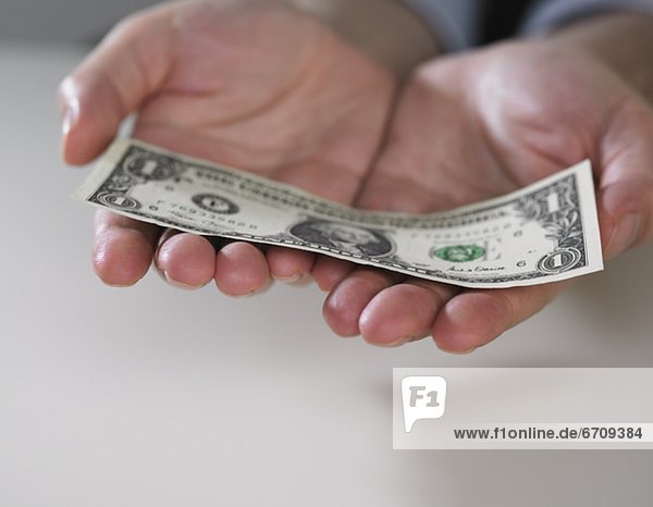 Hands holding an American dollar bill