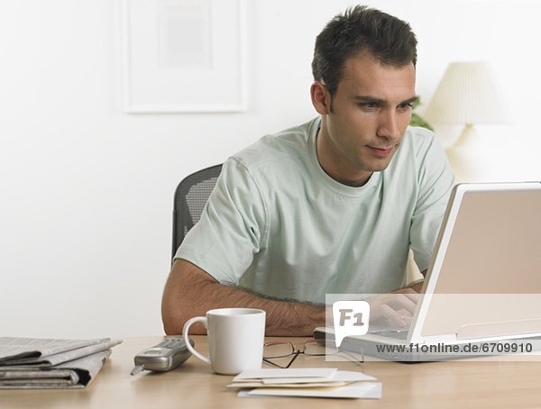 Man using laptop at table