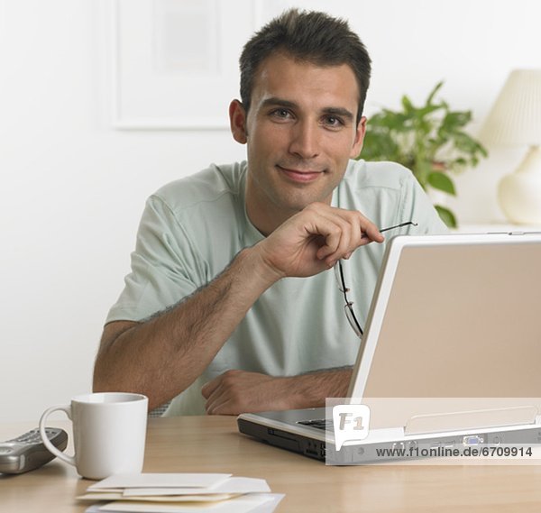 Man using laptop at table