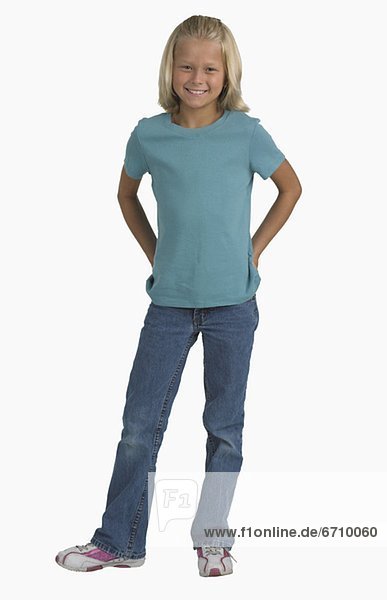 Studio shot of girl with hands in back pockets