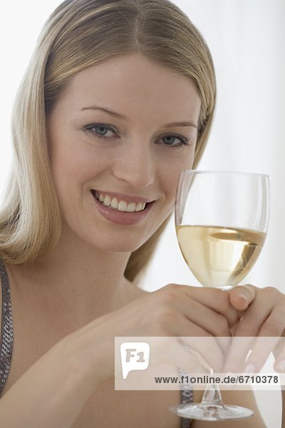 Portrait of woman holding glass of wine