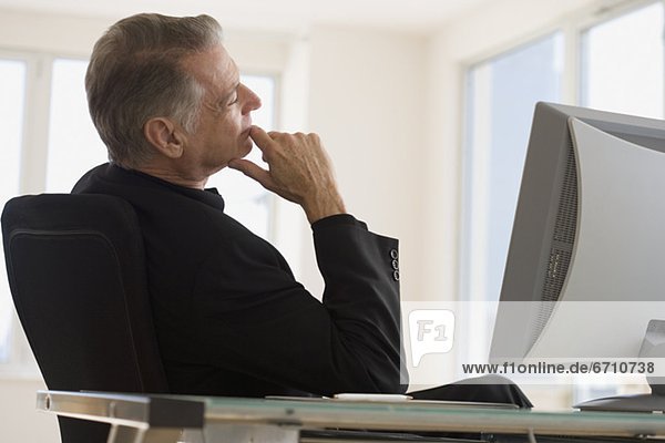 Senior businessman sitting at desk