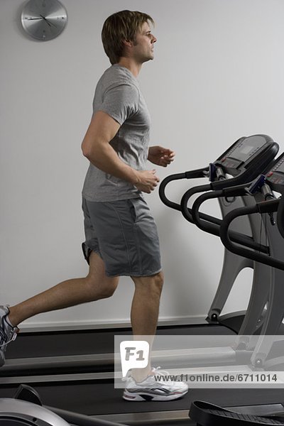 Man running on treadmill at health club