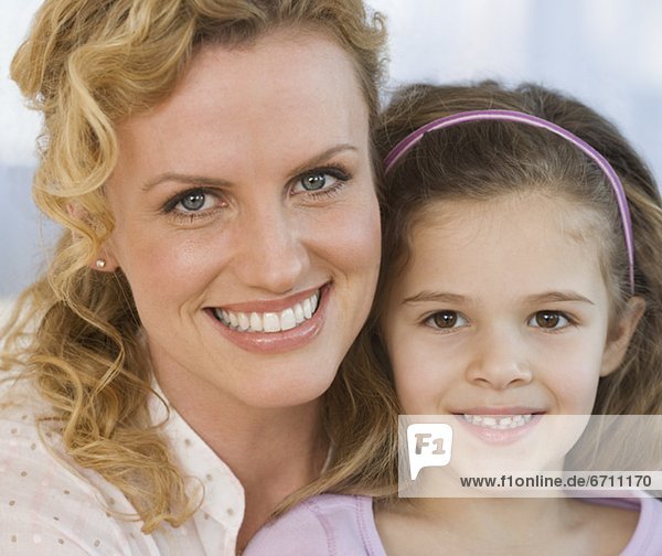 Close up of mother and daughter smiling