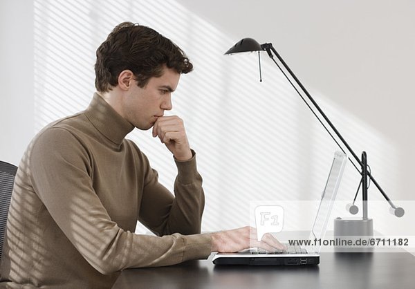 Businessman typing on laptop