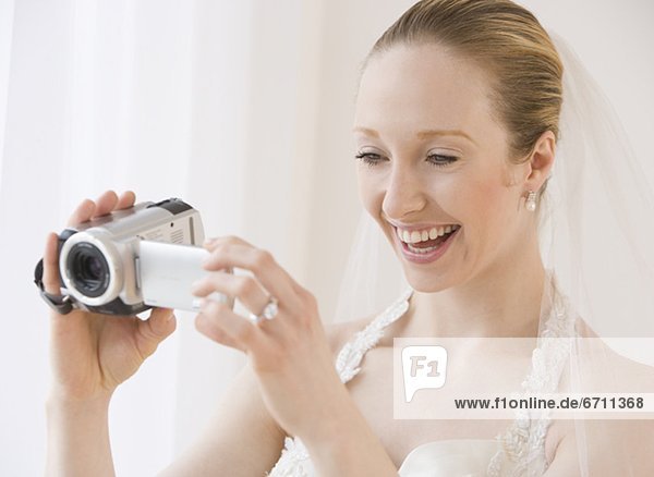 Bride using video camera