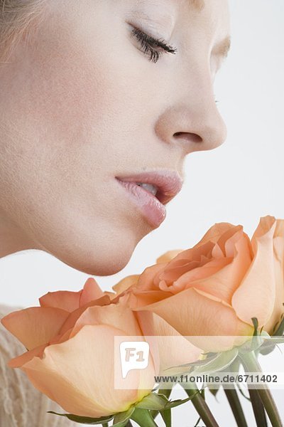 Close up of Woman smelling flowers