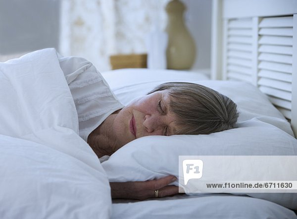 Senior woman sleeping in bed
