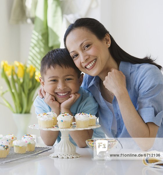 Asian mother and son with cupcakes