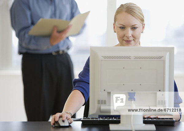 Businesswoman using computer at desk