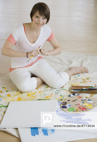 Woman painting on floor