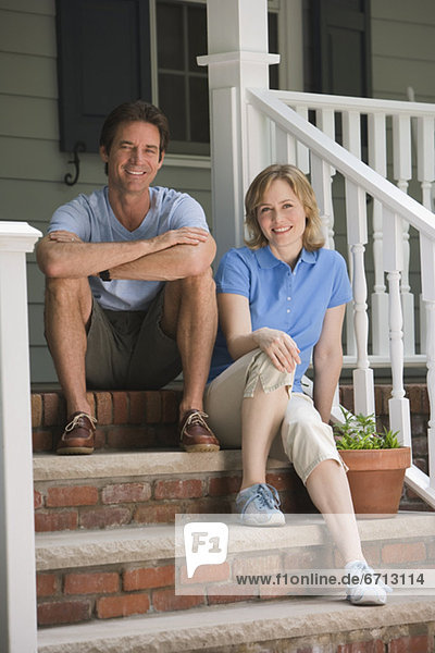Couple sitting on porch steps
