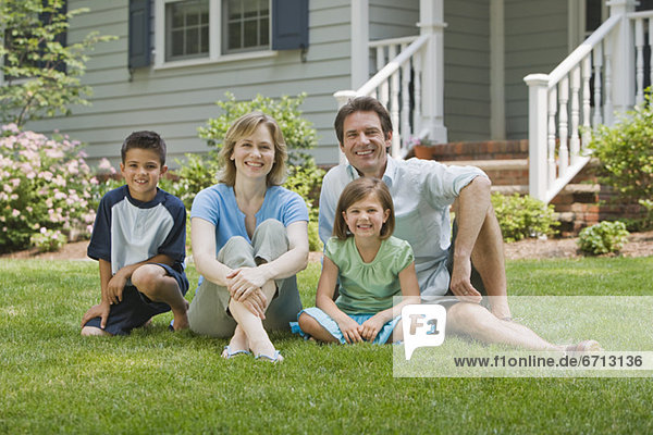 Family sitting on lawn