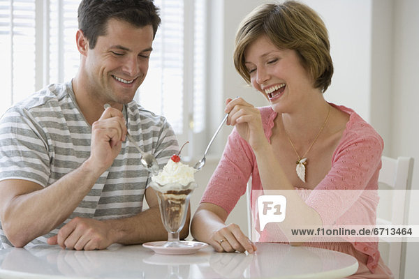 Couple sharing ice cream sundae