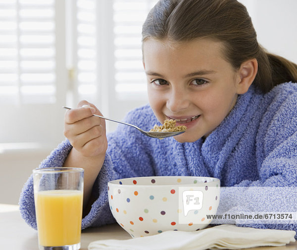 Girl eating breakfast cereal