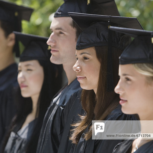 Group of college graduates in row