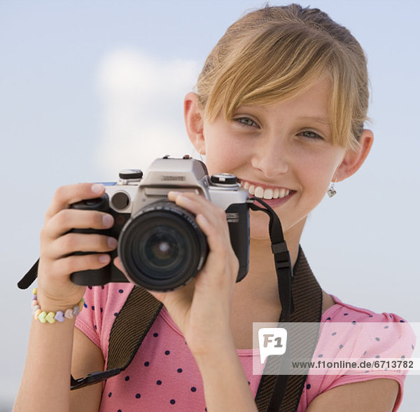 Teenaged girl holding camera