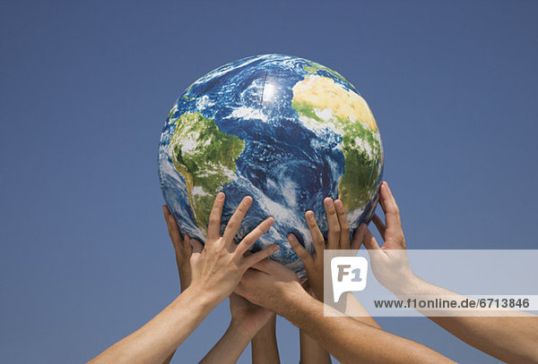Hands holding up globe