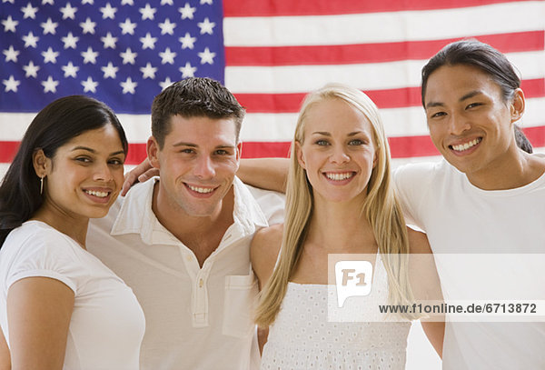 Multi-ethnic friends in front of American flag