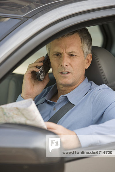 Man looking at map in car