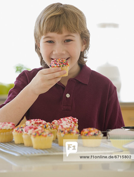 Boy eating home-made cupcake