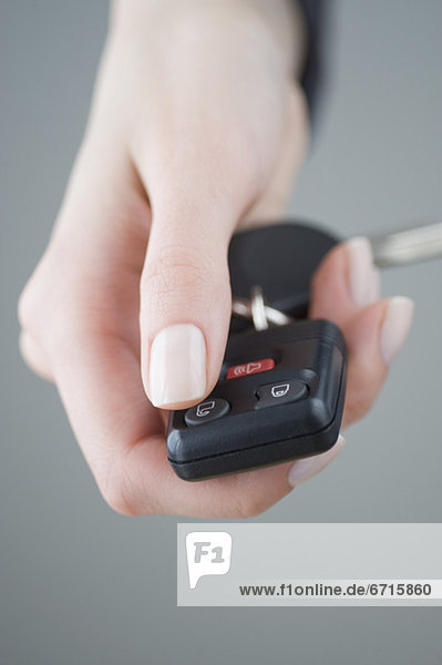 Woman pressing unlock button on keychain