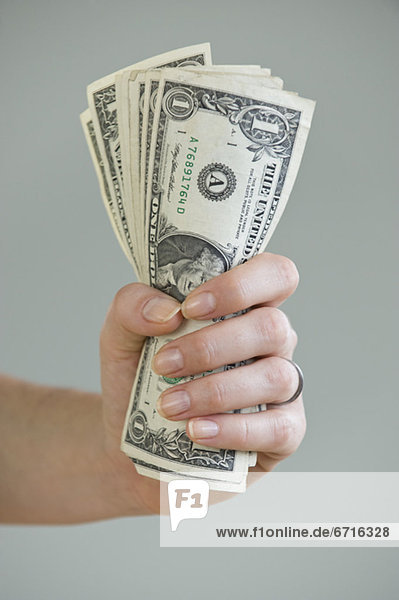 Woman holding handful of money
