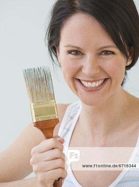 Woman holding paintbrush